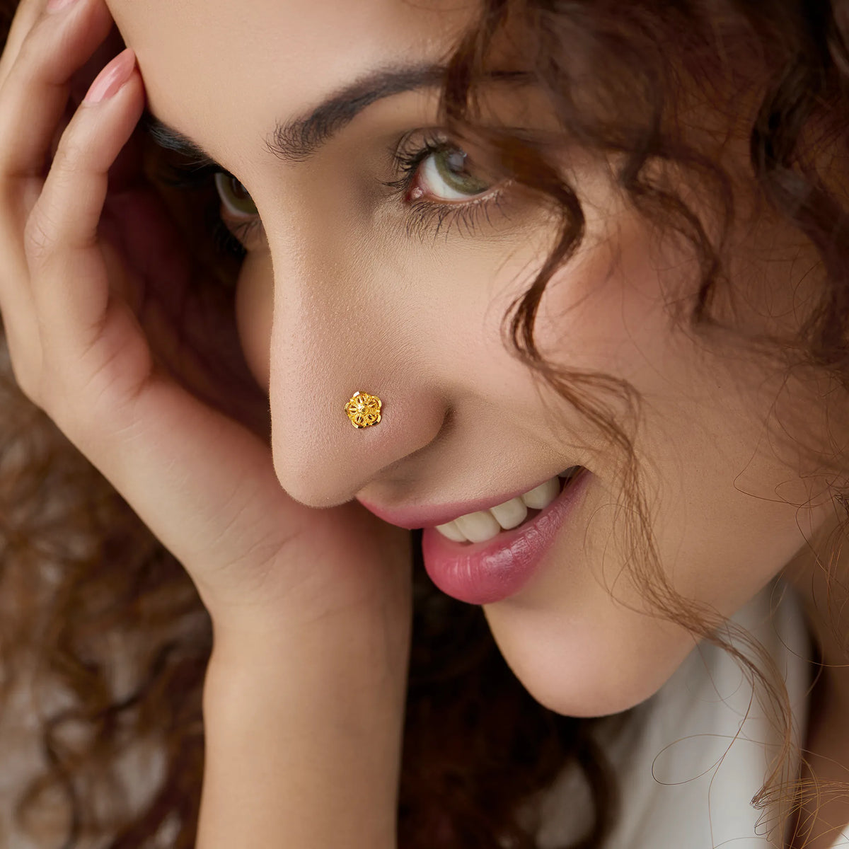 Woman wearing a small floral gold nose pin showing a graceful and elegant everyday style