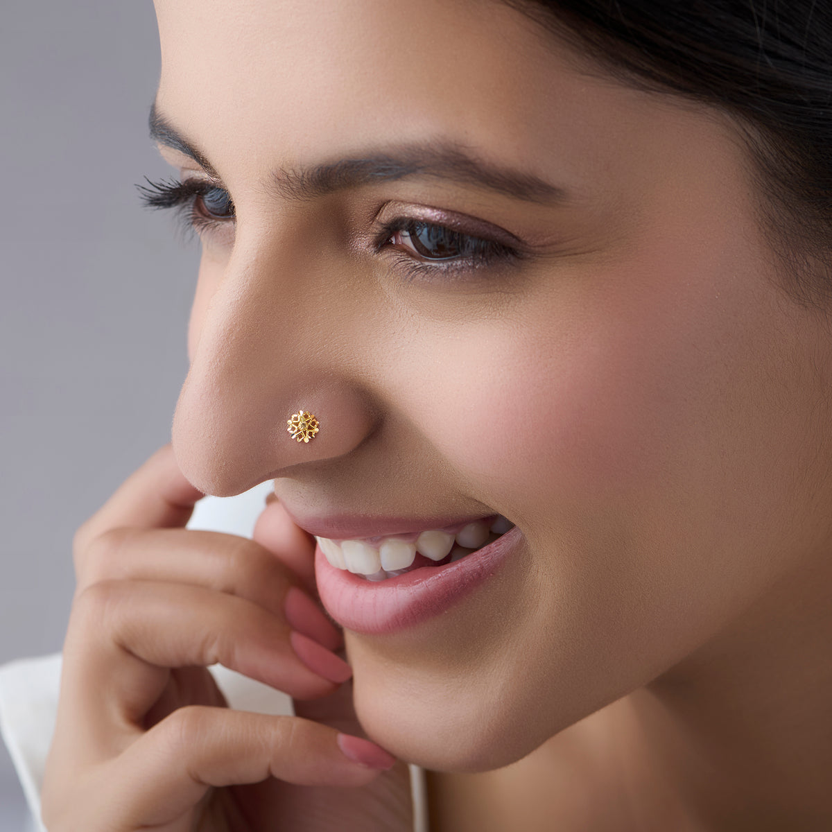 Woman wearing a small floral gold nose pin showcasing a graceful everyday look