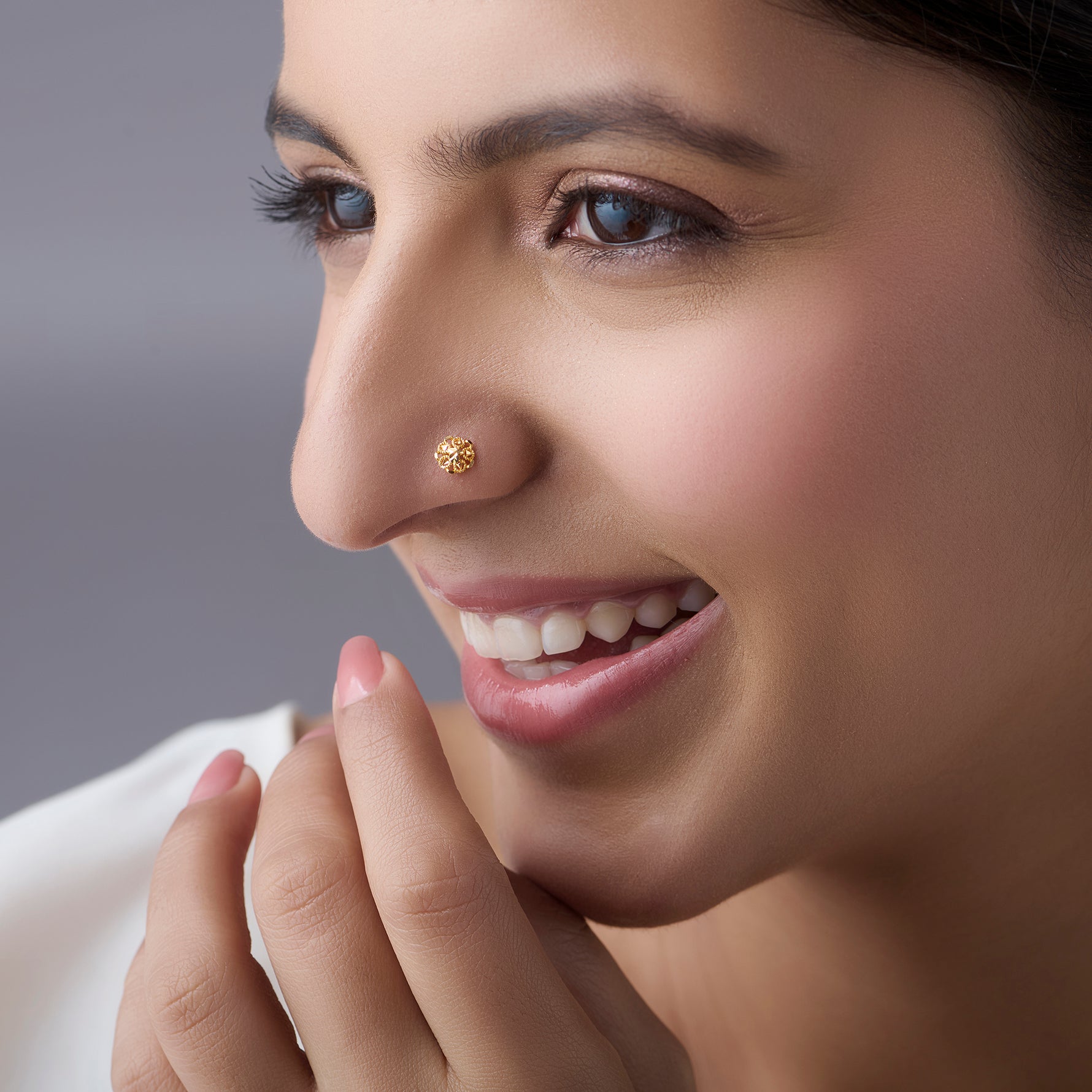 Woman wearing a delicate floral gold nose pin showing an elegant and minimal everyday style
