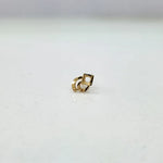 Small geometric 18K nose pin gold captured on a clean background highlighting its polished finish