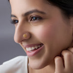 Woman wearing delicate gold nose pin design showcasing traditional indian gold nose pin style for daily wear