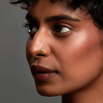 Woman wearing multicolour butterfly 18K gold nose pin showcasing a bold and modern ethnic look