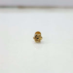 Close-up view of knot motif 18K nose pin gold on a white background showing fine handcrafted detailing