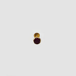 Gold stone nose pin with black gemstone front view on white background