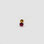 Close up of ruby stone gold nose pin on neutral background