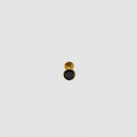 Minimal gold nose pin with black gemstone isolated on white background