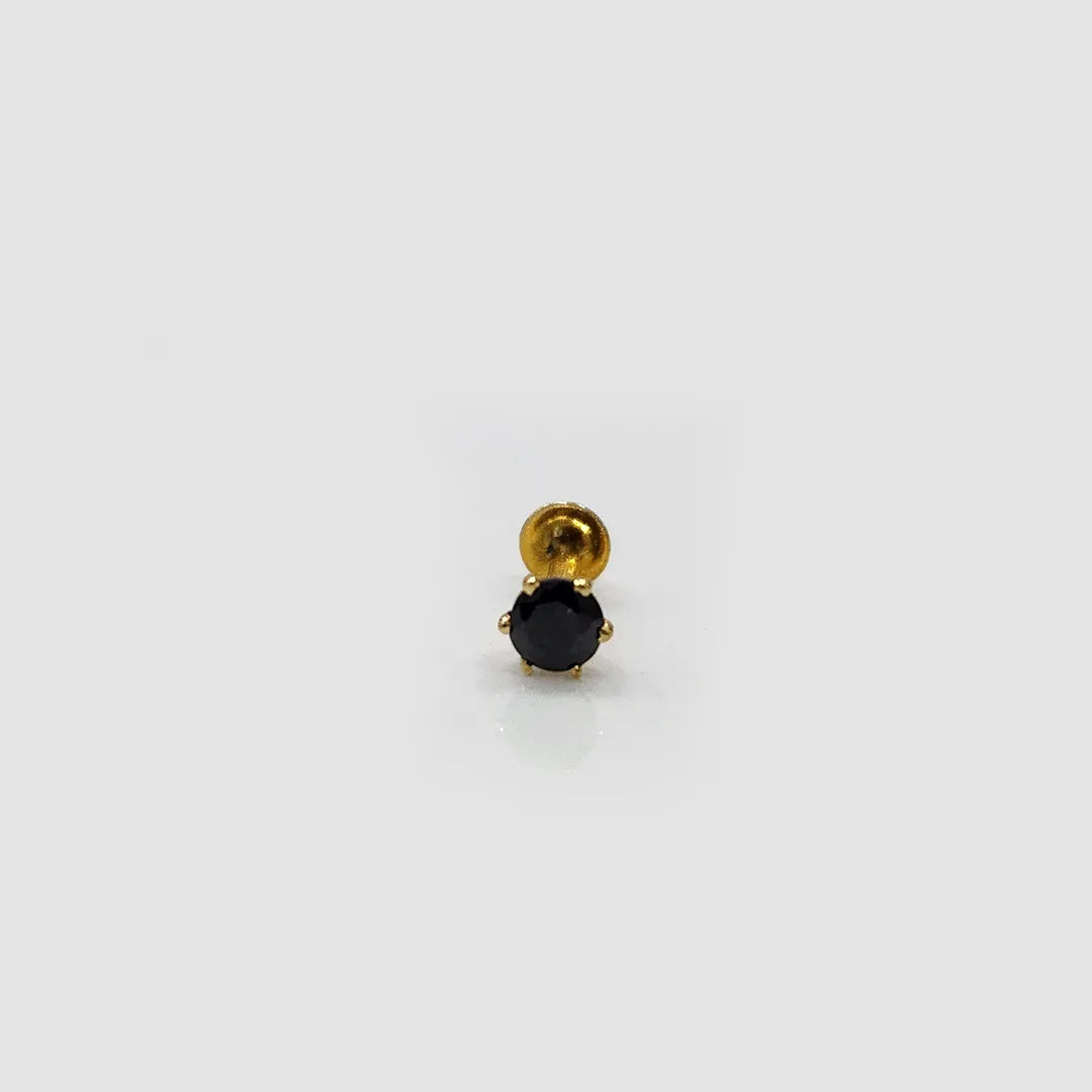 Front view of blue stone gold nose pin with prong detailing