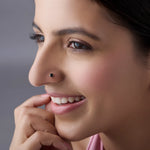 Woman wearing black stone gold nose pin styled for modern look