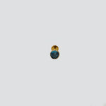 Front view of gold nose pin with round blue gemstone on white background