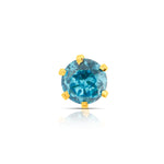 Close up of blue gemstone gold stone nose pin with prong setting