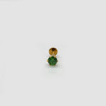 Gold stone nose pin with green gemstone on a white background