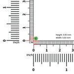 Scale view of green stone nose pin beside ruler