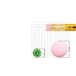 Size reference image of green stone gold nose pin on grid