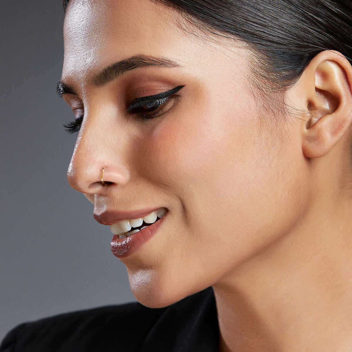 Model profile wearing a plain 18K gold hoop nose ring showcasing understated everyday styling