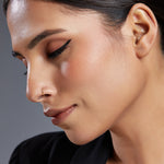 Model wearing a plain 18K gold hoop nose ring demonstrating subtle everyday elegance