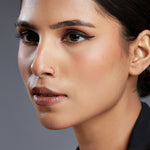 Woman wearing a simple ball accent gold nose ring showcasing elegant everyday styling on the face