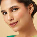 Model front facing portrait wearing a plain gold hoop nose ring for a clean elegant look
