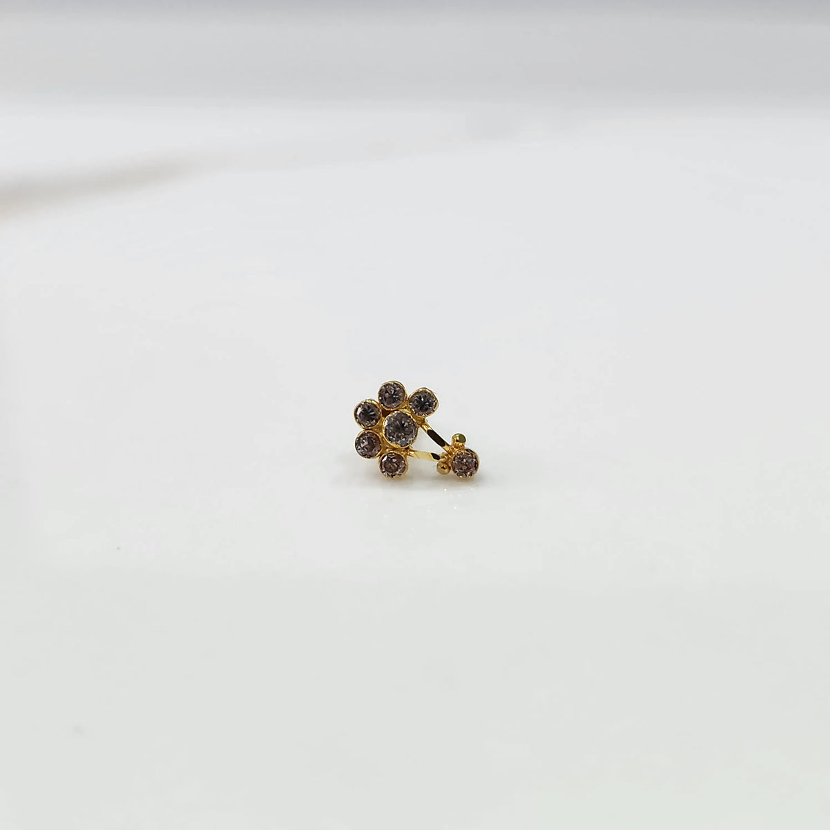 Antique-style gold ring with amethyst-toned stones plus hanging accent