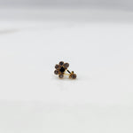 Antique-style gold ring with amethyst-toned stones, onyx center, plus hanging accent