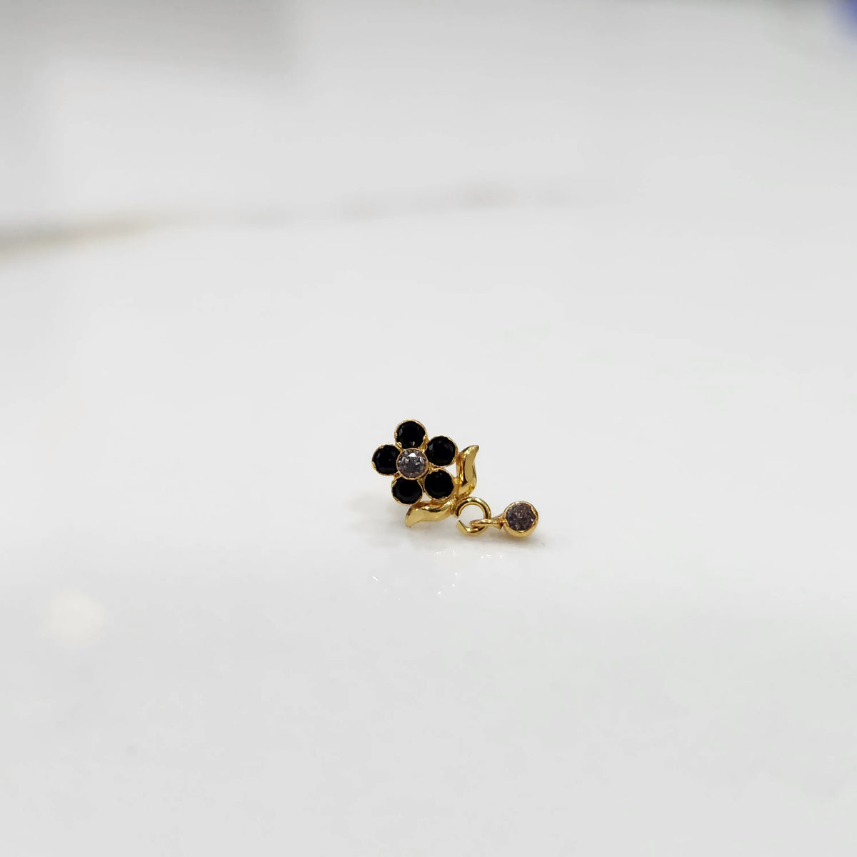 Gold ring with black onyx floral dangle design, side view