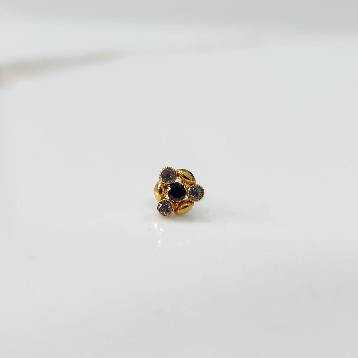 Gold ring with black onyx leaf-petal design, front view