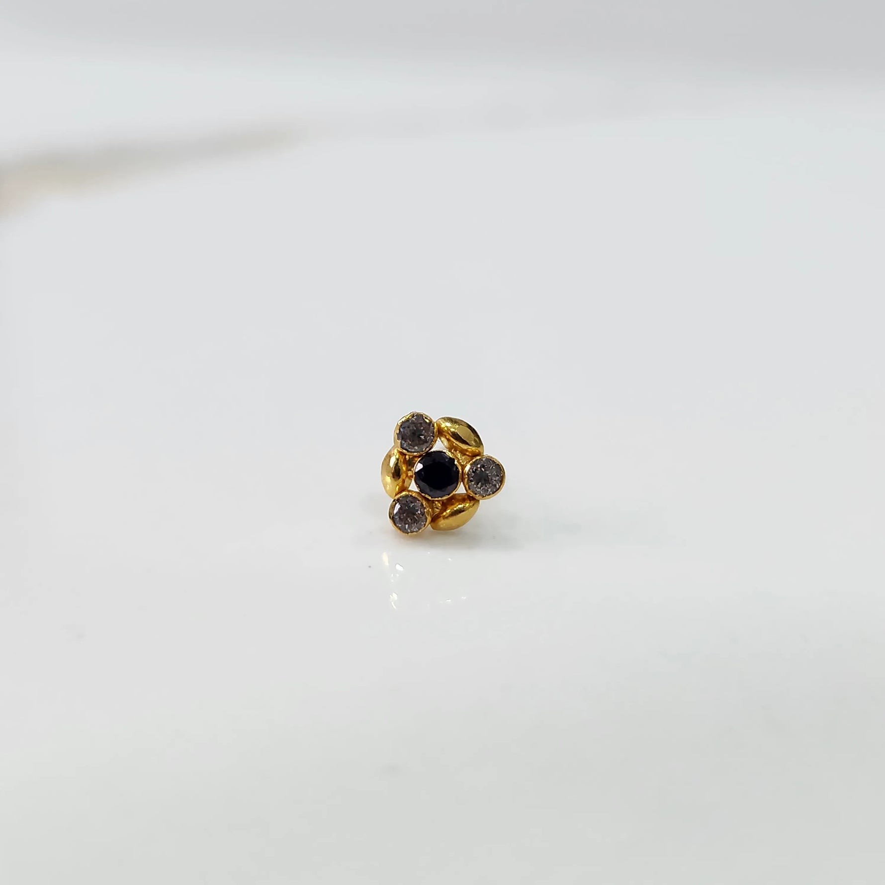Gold ring with black onyx leaf-petal design, front view