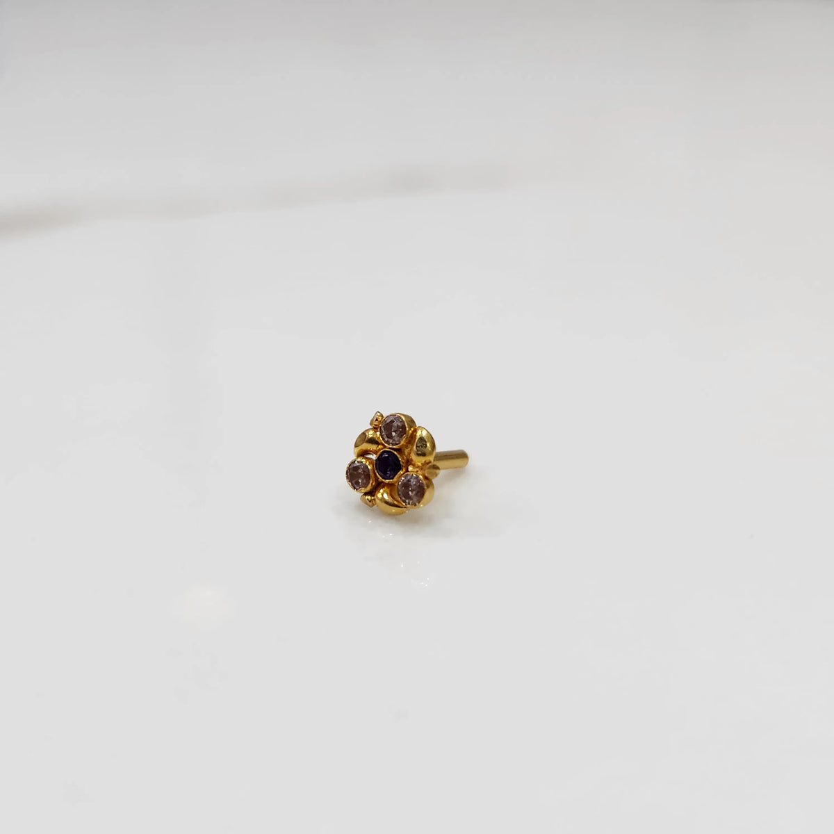 Antique-style gold ring with blue and purple-toned stones in round floral pattern