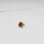 Antique-style gold ring with blue and purple-toned stones in round floral pattern