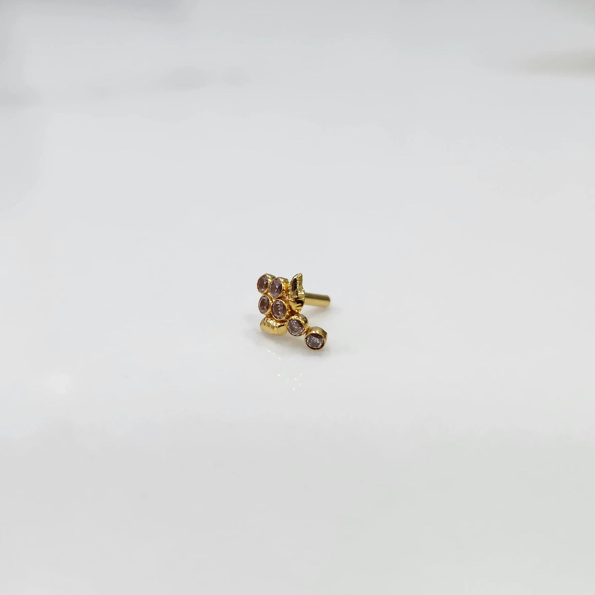 Side view of gold ring featuring brown gemstone cluster with leaf accent