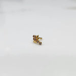 Side view of gold ring featuring brown gemstone cluster with leaf accent