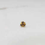 Side view of gold ring featuring brown gemstone cluster in round floral pattern