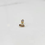 Antique-style gold ring featuring a square stone and hanging brown gems