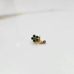Side view of gold ring featuring green gemstone cluster with drop charm accent