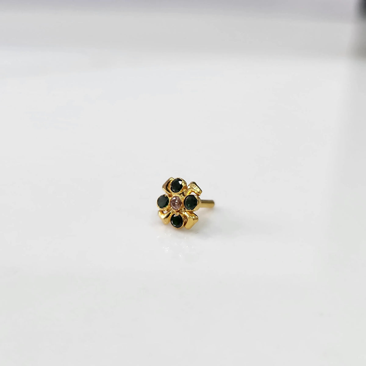 Gold ring with green emerald scalloped floral design, side view
