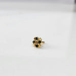 Gold ring with green emerald scalloped floral design, side view