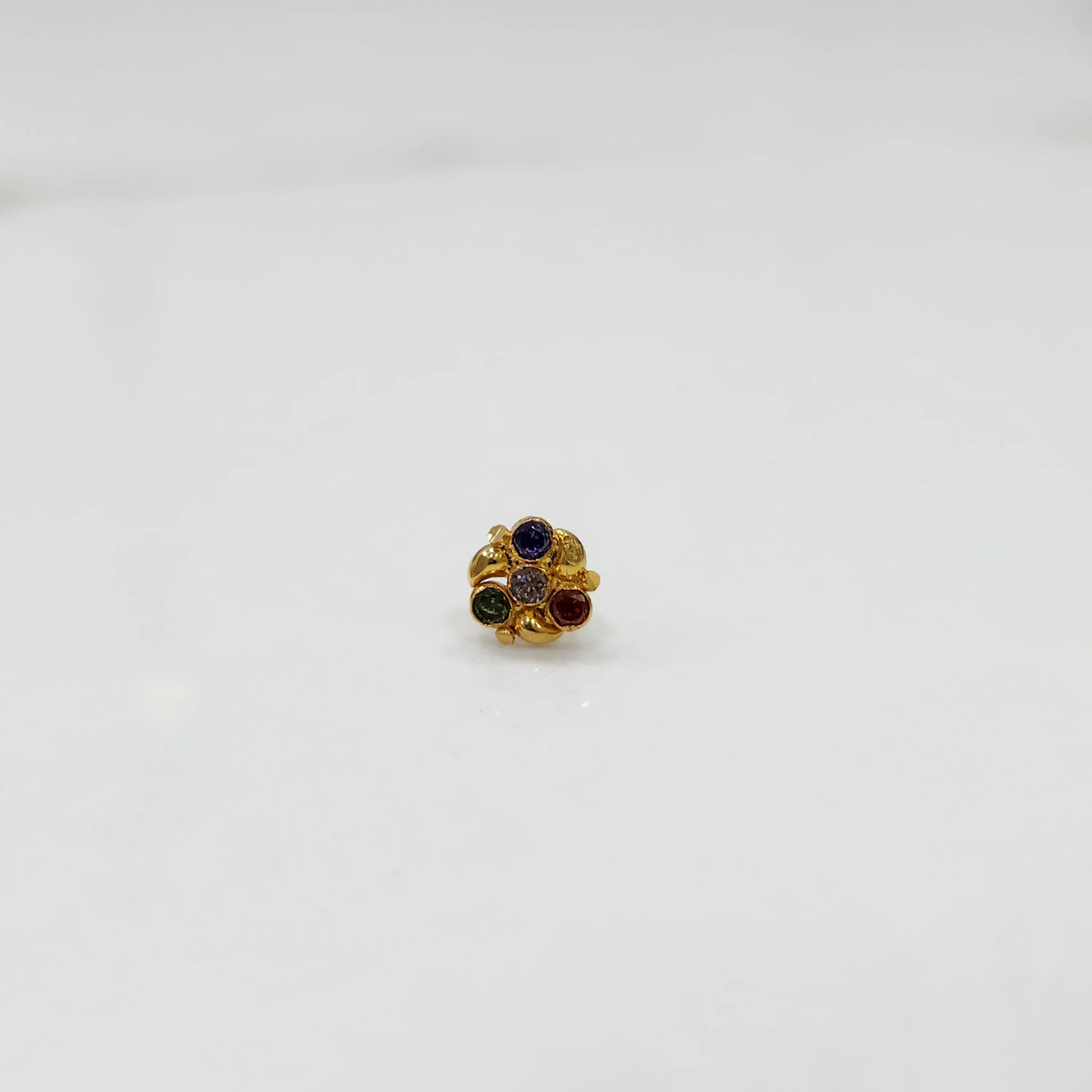 Side view of gold ring featuring multicolor gemstone cluster in round floral pattern