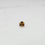 Side view of gold ring featuring multicolor gemstone cluster in round floral pattern