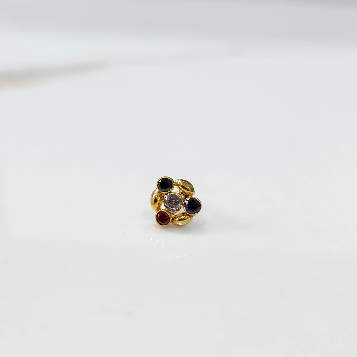 Gold ring with multicolor gemstone leaf-petal design, front view