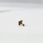 Gold ring with multicolor garnet-toned branch-style gemstone cluster, side view