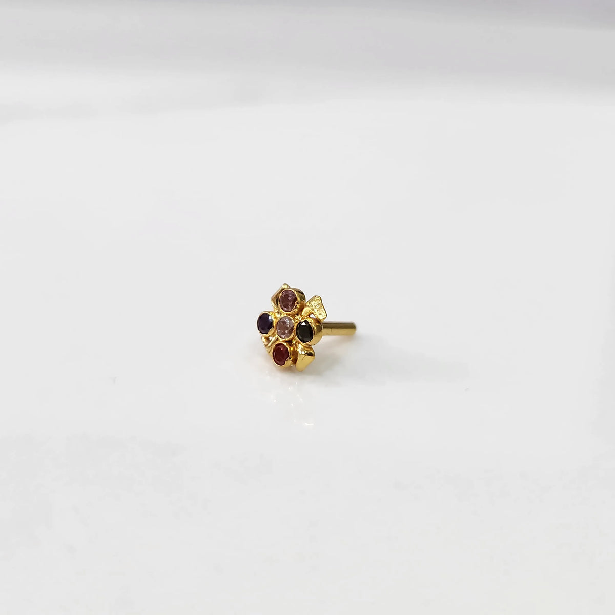 Gold ring with multicolor garnet scalloped floral design, top view