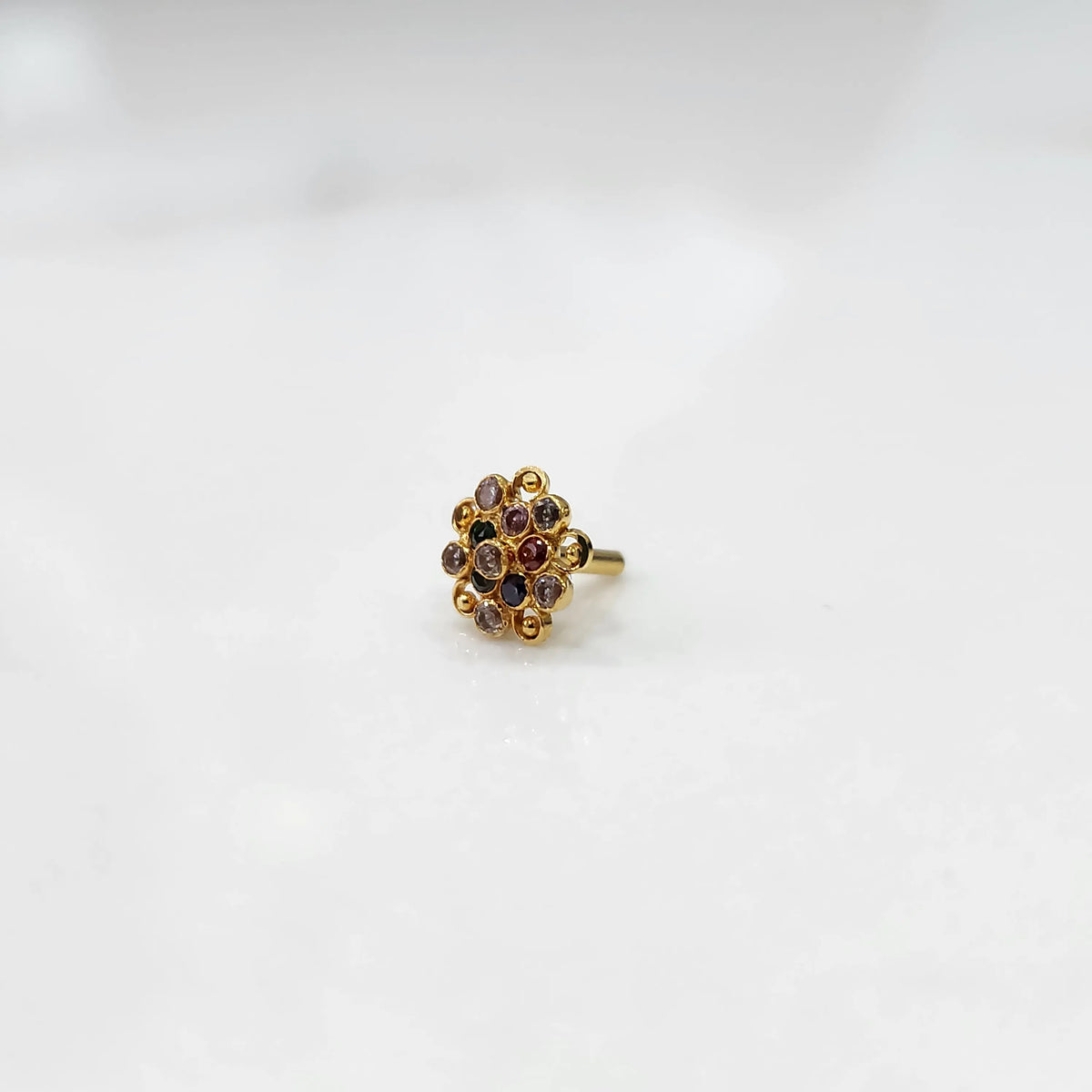 Front view of gold ring with layered multicolor gemstone petals