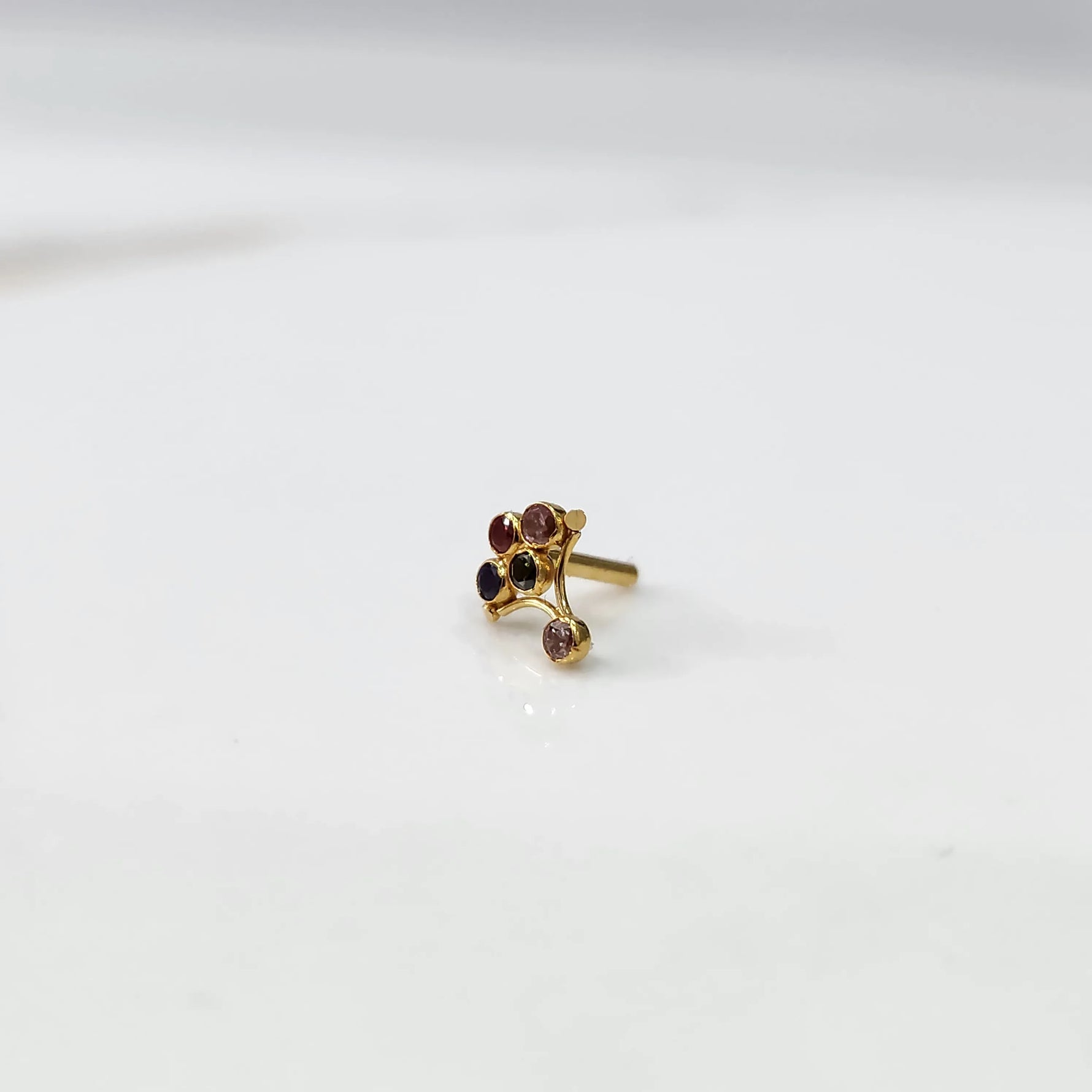 Gold ring with multicolor purple-toned scalloped floral design, side view