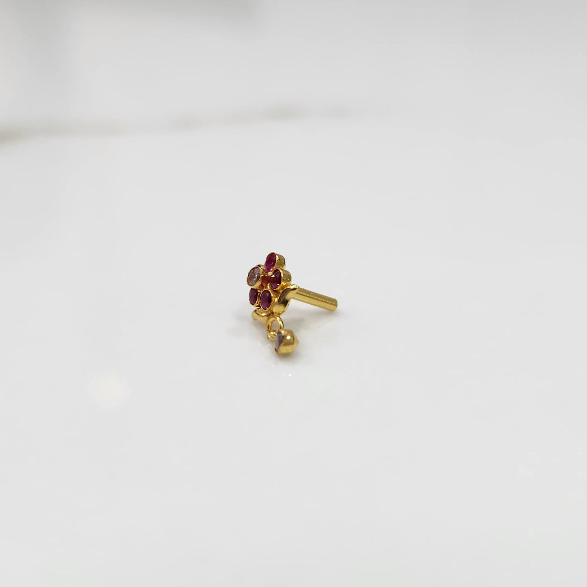 Antique-style gold ring with red-toned stones in floral dangle pattern