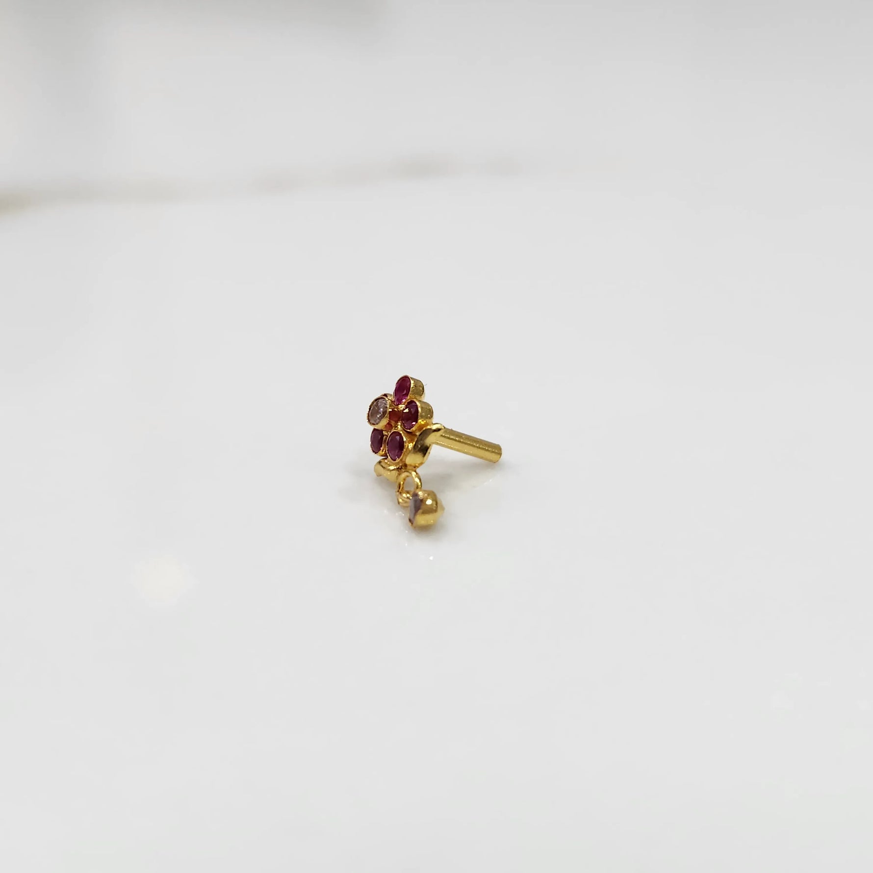 Antique-style gold ring with red-toned stones in floral dangle pattern