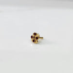 Gold ring with red garnet scalloped floral design, side view
