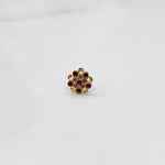 Front view of gold ring with layered red and clear gemstone petals