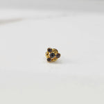 Antique-style gold ring with smoky-toned stones in leaf-petal pattern, angled view