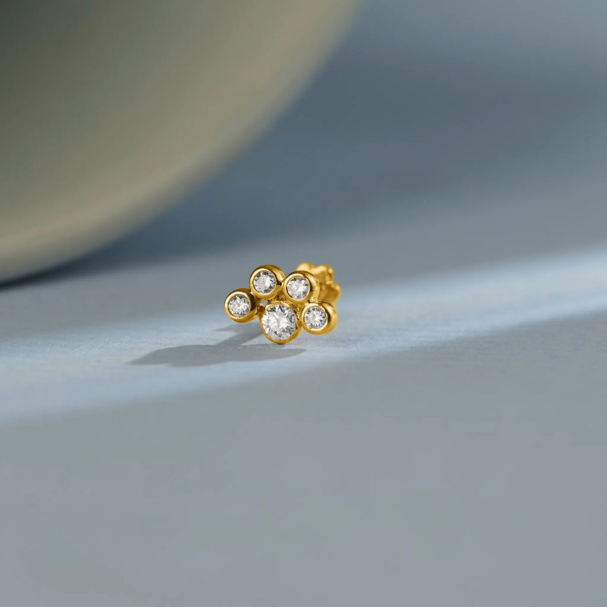 Minimal floral lab grown diamond nose pin with round stones on soft background