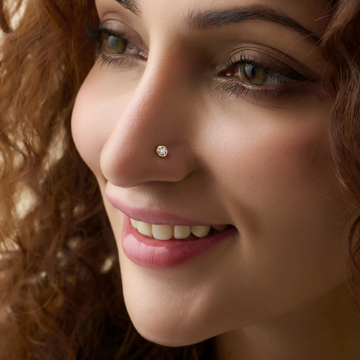 Woman wearing elegant Kerala style gold diamond nose pin close-up portrait