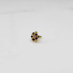 Sapphire flower cluster nose stud with gold heart setting, jewelry photography